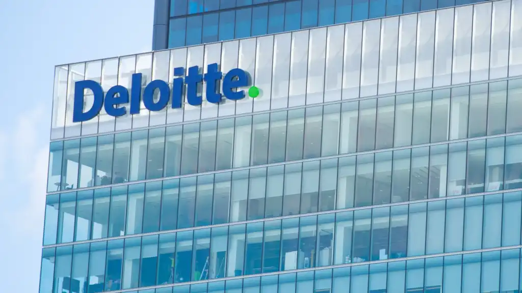 A photograph of a building with the Deloitte logo on the facade.