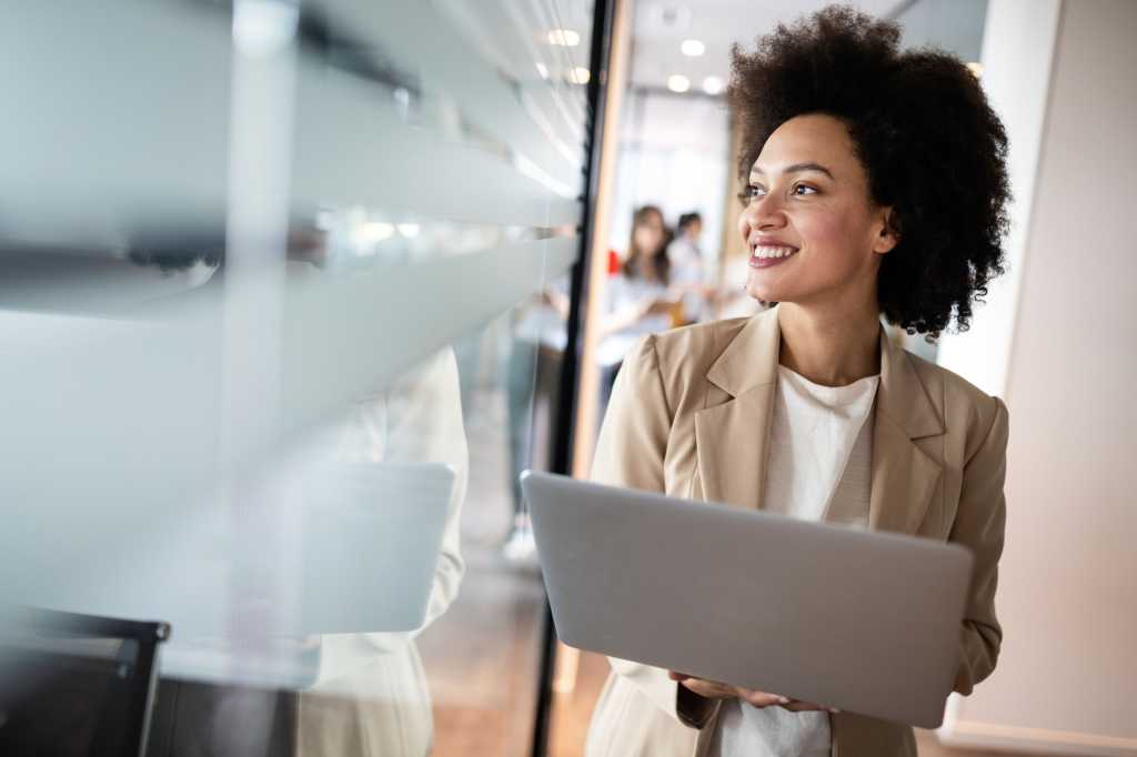 woman holding laptop